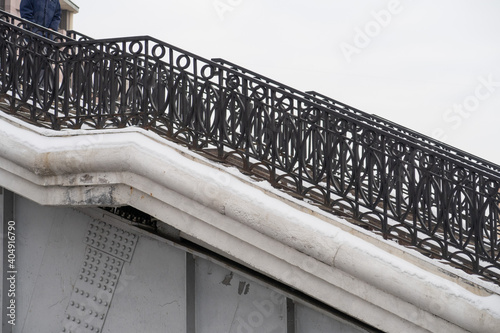 Load bearing structures, metal railings and stone steps are covered with a thin layer of snow, Shluzovoy pedestrian bridge, Vodootvodny canal, Moscow. photo