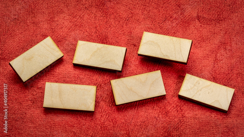 set of blank wooden blocks on red handmade textured paper