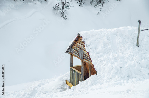 Minimalist winter landscape with wooden house in snowy mountains. landscape photography