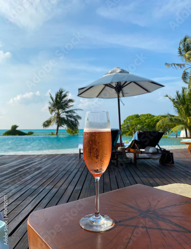 South Male Atoll  Maldives. A glass of cold champagne on the beach background.