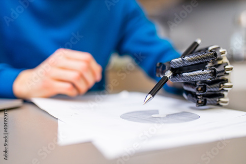 man with prosthetic hand writing development at home