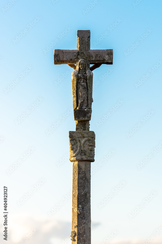 old stone cross on a blue sky old stone cross on a blue sky
