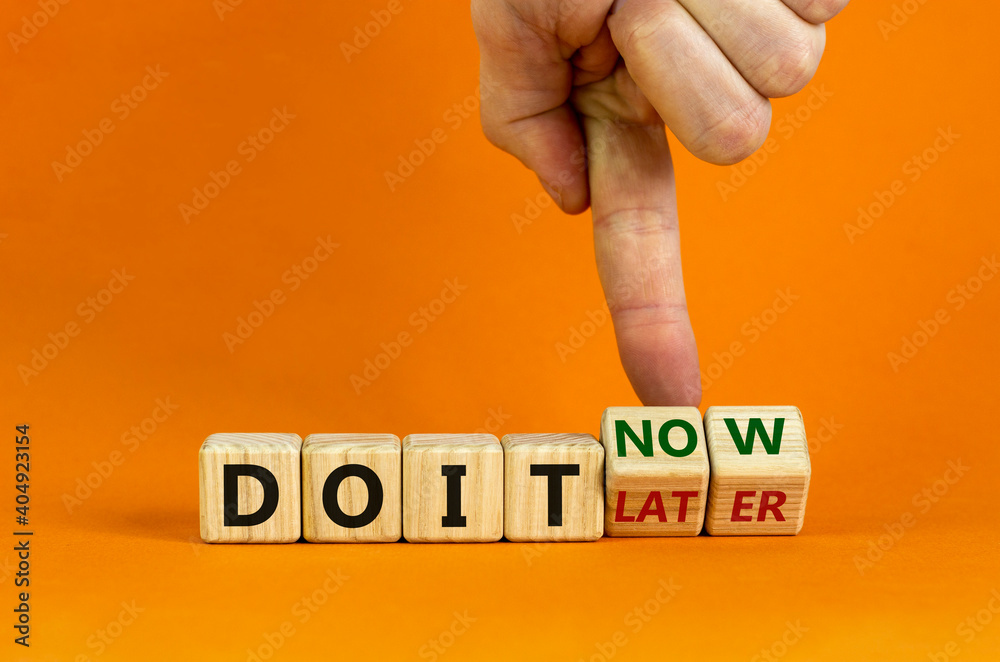 Do it now symbol Businessman hand turns cubes and changes words do it