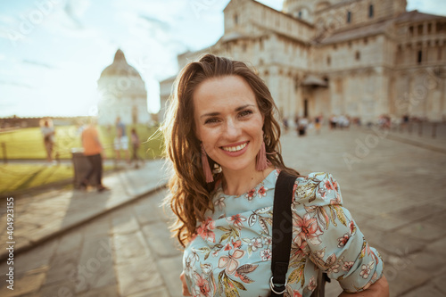 Wallpaper Mural smiling stylish traveller woman in floral dress sightseeing