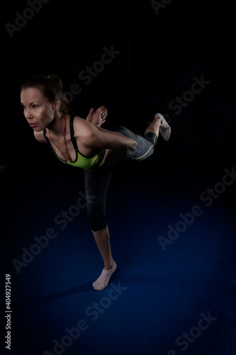 girl doing yoga standing on one leg bend