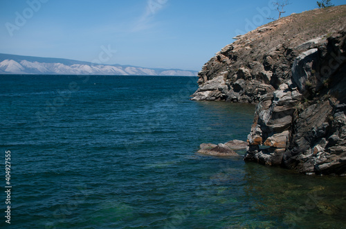 Turquoise water of Lake Baikal with a rock