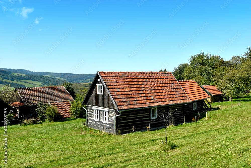 Typical country cottage in the White Carpathians, small house with a red roof, wooden walls, views of the region, village Zitkova, Czech republic