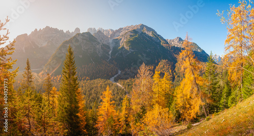 Panoramic view of magical nature in Dolomites at the national park Three Peaks (Tre Cime, Drei Zinnen) during sunset and golden Autumn, South Tyrol, Italy.