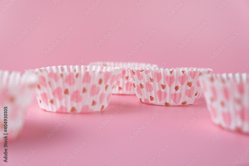 empty pink cupcake mold with hearts on a pink background. Valentine's Day empty pink cupcake mold with hearts on a pink background. Valentine's Day