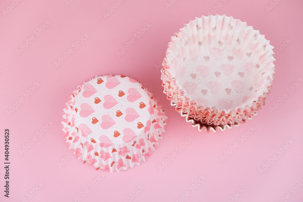 empty pink cupcake mold with hearts on a pink background. Valentine's Day empty pink cupcake mold with hearts on a pink background. Valentine's Day