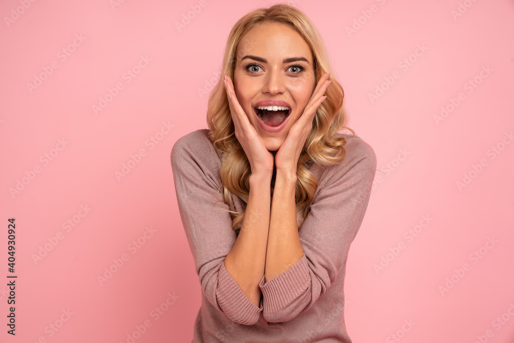 Image of excited screaming young woman standing isolated over pink background. Image of excited screaming young woman standing isolated over pink background.