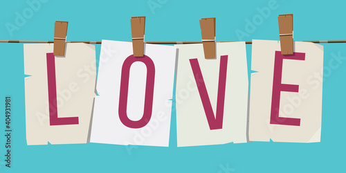 Word "Love" attached to the rope with hairpins