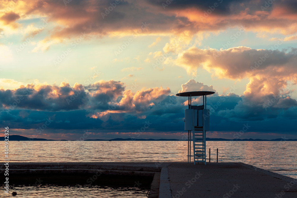 Lifeguard observation tower on the beach at sunset