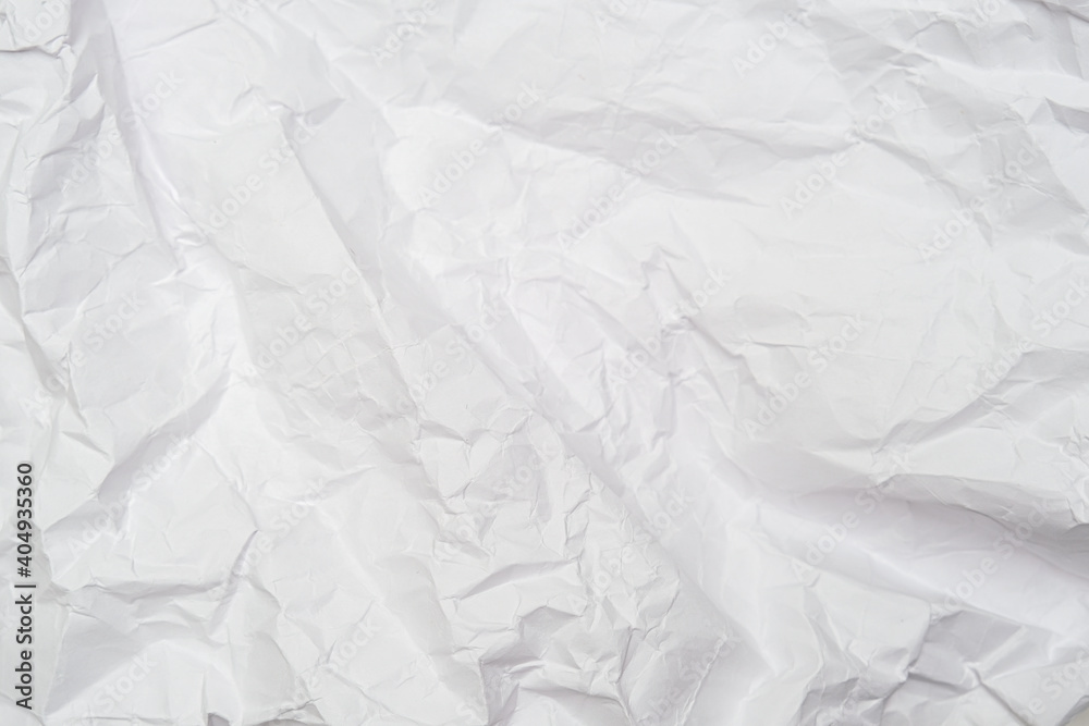 Fototapeta premium A background of sheet of white crumpled paper with wrinkles, backdrop for design and web