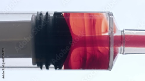 Filling syringe with vaccine sample in blood with saline solution clinical trial procedure