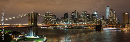 Panoramic View on Manhattan Skyline and Brooklyn Bridge at Night 