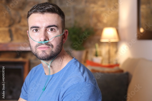 Man receiving oxygen through nasal tube  photo