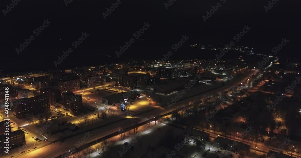 Aerial view of hospital at night. Winter city landscape. Snowy streets with cars at night. Aerial view of hospital at night. Winter city landscape. Snowy streets with cars at night.