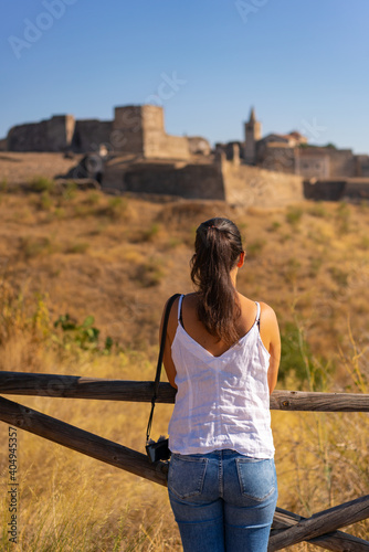 Caucasian woman looking at Juromenha castle on a summer day in Alentejo, Portugal photo