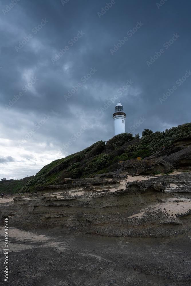 Light house with dark stormy sky in the background