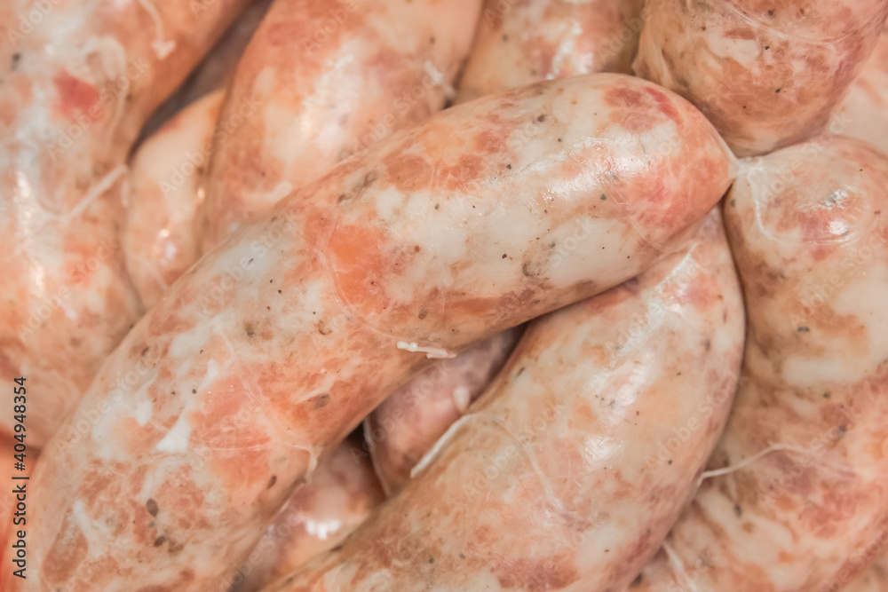 Cooking sausages from raw minced meat background Cooking sausages from raw minced meat background