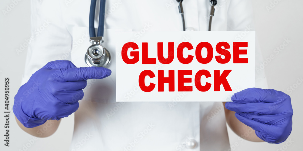 The doctor points his finger at a sign that says - GLUCOSE CHECK The doctor points his finger at a sign that says - GLUCOSE CHECK