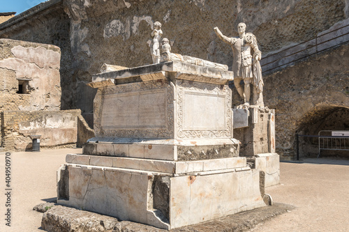 Marble statues among Herculaneum's ruins, marble altar and statue of the donator of the basilica , proconsul Marcus Nonius Balbus photo