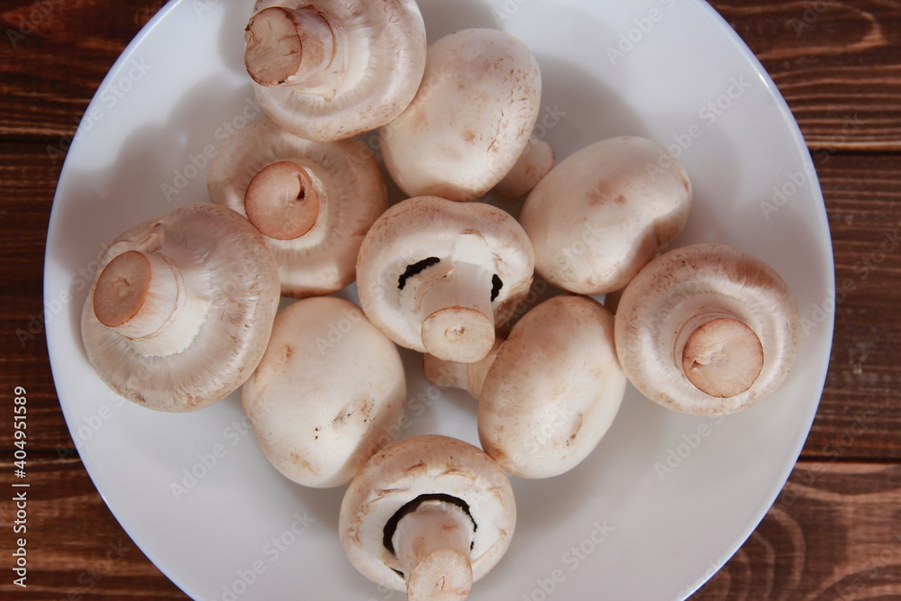 fresh champignons close-up on a wooden table Vegetarian food. Proper nutrition fresh champignons close-up on a wooden table Vegetarian food. Proper nutrition