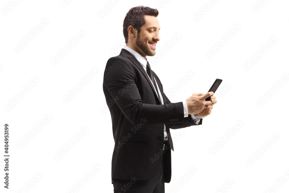 Businessman smiling and typing on a phone Businessman smiling and typing on a phone