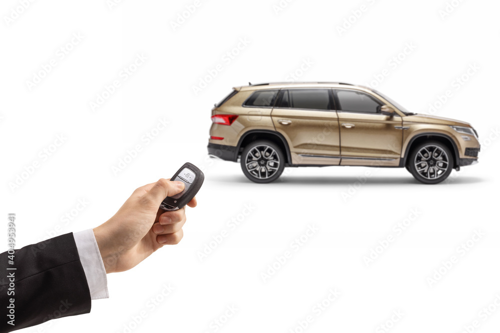 Male hand in a suit unlocking a SUV with a remote key