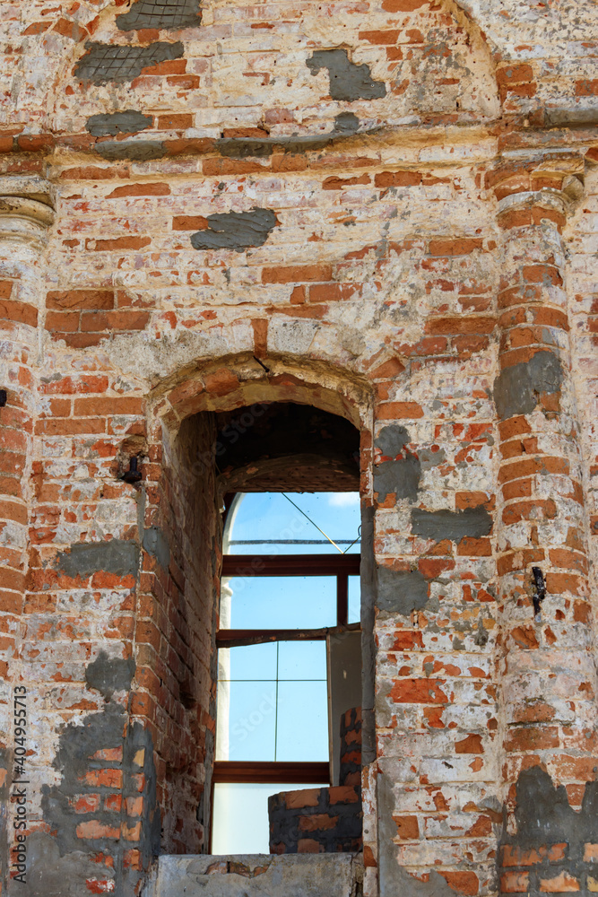 Arch window on the red brick wall in old building