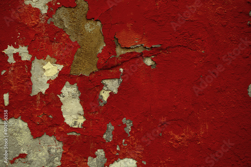 Background texture of old flaking red paint on a wall exposing the concrete below in a full frame view. This is a lighter version, a darker version is also available in the portfolio