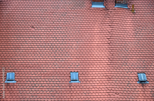 Red tile roof with windows as background