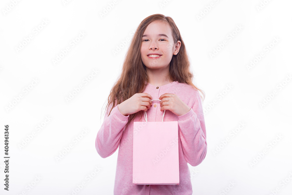 Portrait of cheerful child girl holding pink shopping bag. Portrait of cheerful child girl holding pink shopping bag.