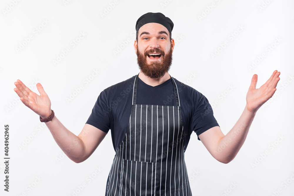 Naklejka premium Photo of cheerful Chef man with beard making welcome gesture.