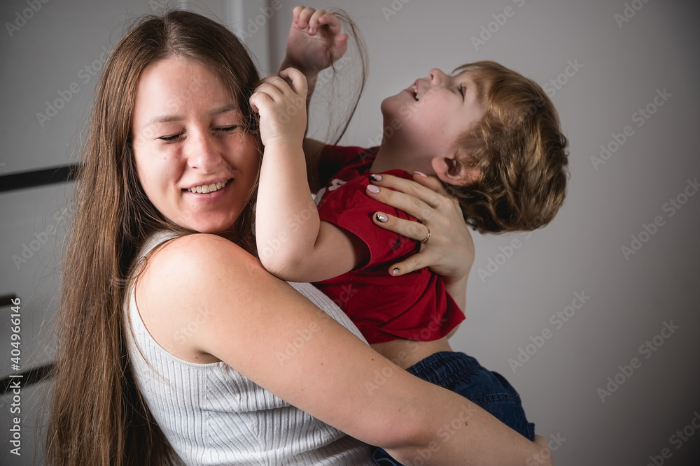 A woman with her son in her arms. Happy family. Real emotions. A woman with her son in her arms. Happy family. Real emotions.