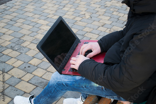 Man working on laptop outdoors