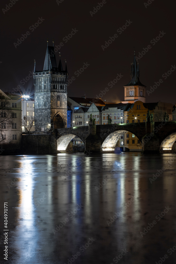 view of Charles Bridge on the river Vltava and light from street sovetleni at night in the center of Prague