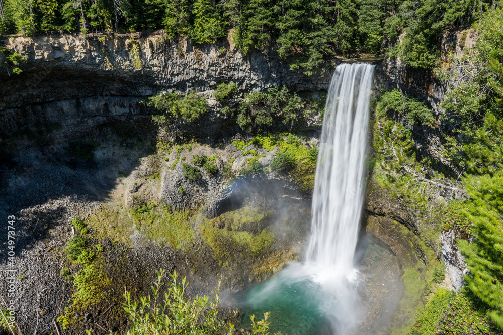 High waterfall falling into a blue water pond High waterfall falling into a blue water pond