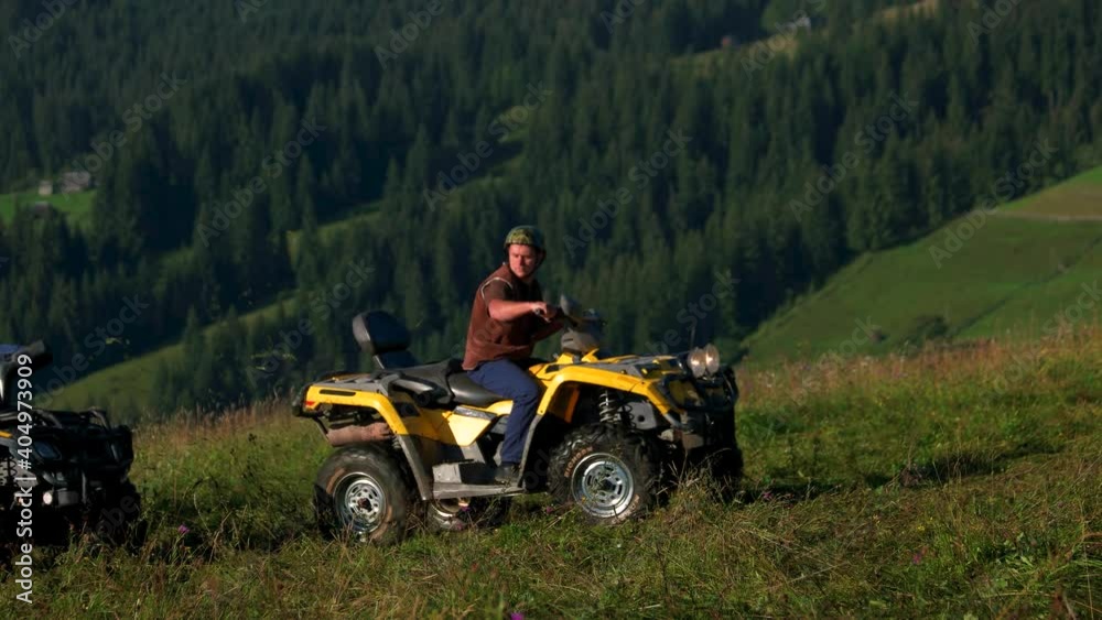 Three tourists on quad bikes in mountain. Three friends riding quad bikes in summer. ATV quad biking adventure. Three tourists on quad bikes in mountain. Three friends riding quad bikes in summer. ATV quad biking adventure.