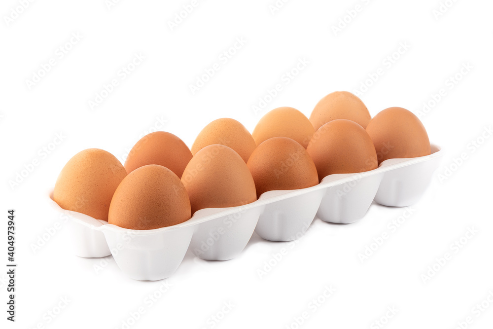 Ten brown eggs on a white plastic substrate isolated on white background. Ten brown eggs on a white plastic substrate isolated on white background.
