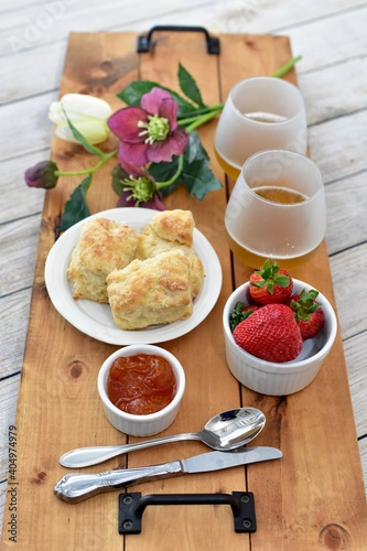 Fototapeta Naklejka Na Ścianę i Meble -  Celebratory Mother's Day brunch for breakfast in bed to honour Mom with gourmet scones and preserves and champagne. 