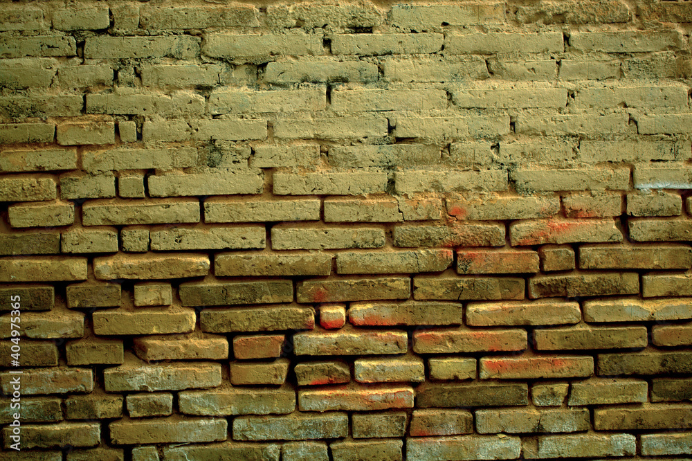 Old weathered clay brick background texture with eroded masonry