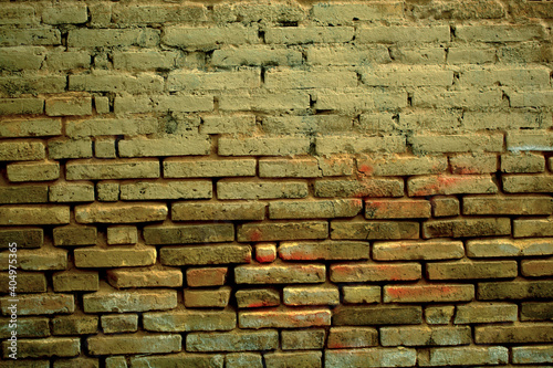 Old weathered clay brick background texture with eroded masonry exposing the bricks in a full frame view. This is a lighter version  a darker version is also available in the portfolio