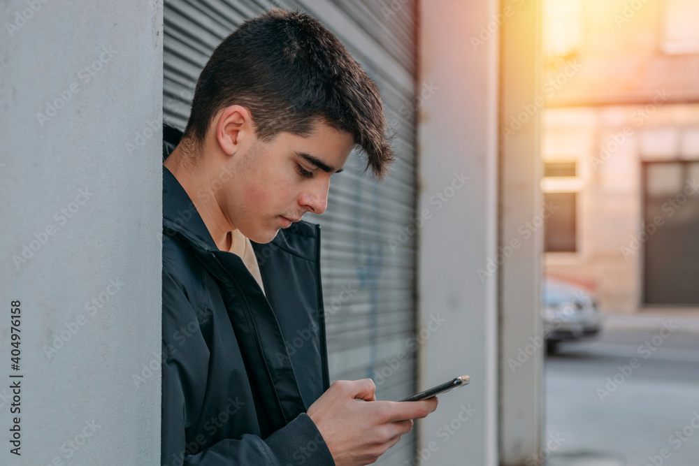 teenager with mobile phone on the street outdoors teenager with mobile phone on the street outdoors