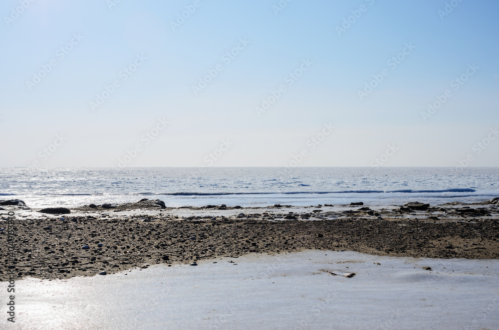 Frozen winter beach with frozen blocks of ice on the shore. Frozen winter beach with frozen blocks of ice on the shore.