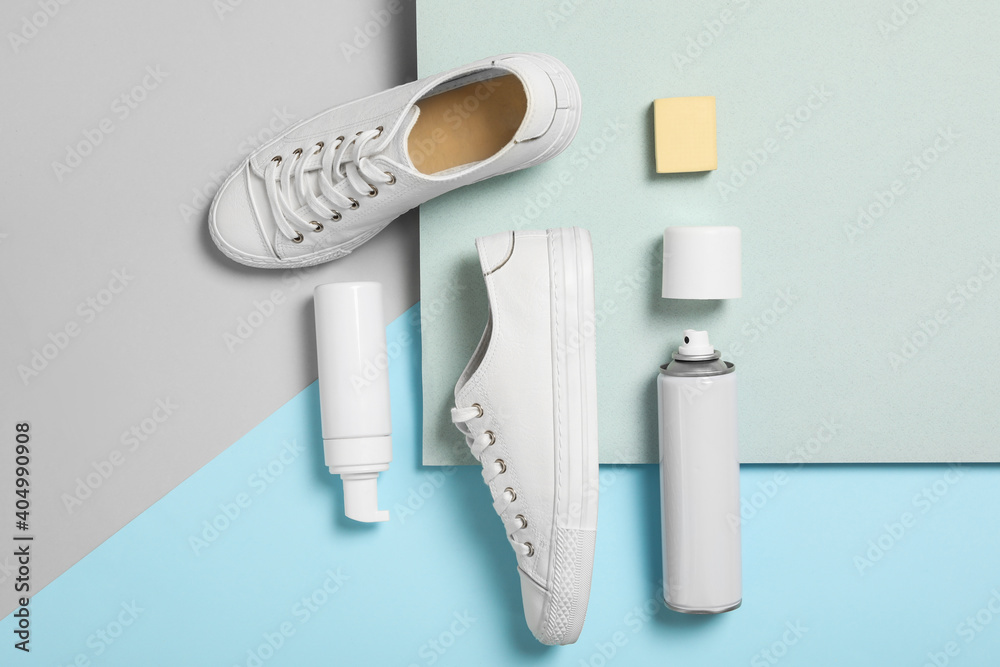 Fototapeta premium Flat lay composition with stylish footwear and shoe care accessories on color background
