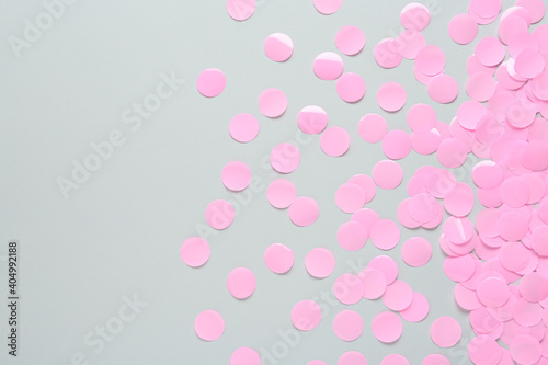 Pink confetti on light grey background, flat lay. Space for text