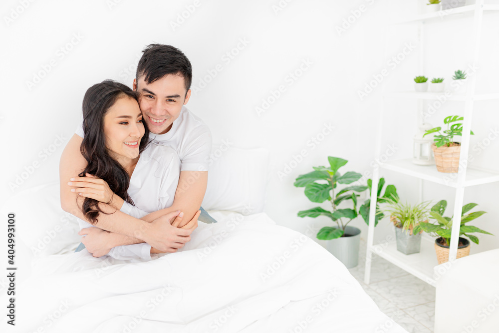 asian lover rest on bed, they use hand hug body together, they feeling love and happy together, happiness honeymoon and valentine's day asian lover rest on bed, they use hand hug body together, they feeling love and happy together, happiness honeymoon and valentine's day