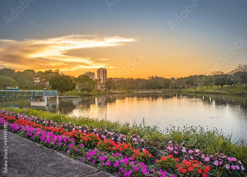 Fototapeta Naklejka Na Ścianę i Meble -  Sunset over the city lake with a beautiful garden, sunset over the river